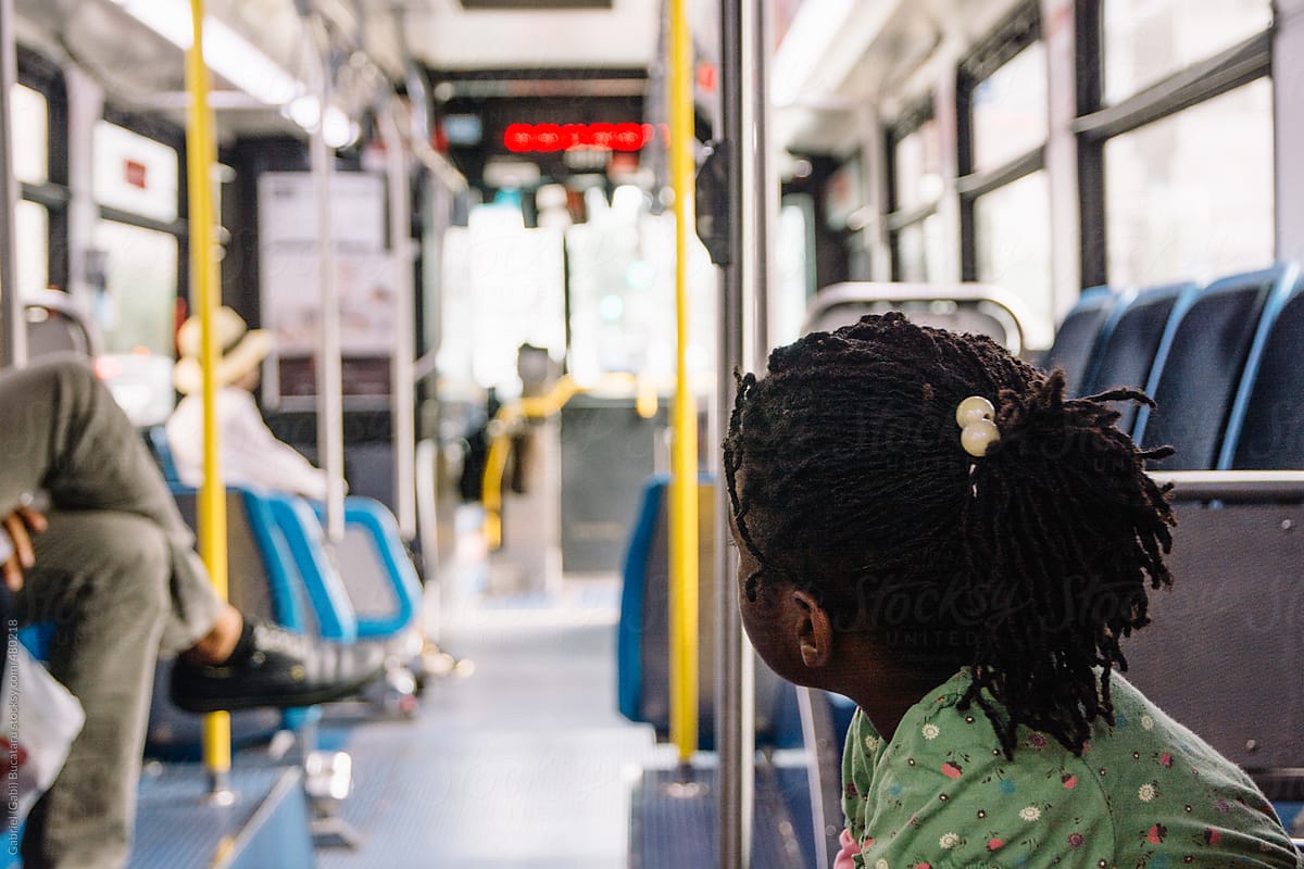 African American girl inside a bus in a city