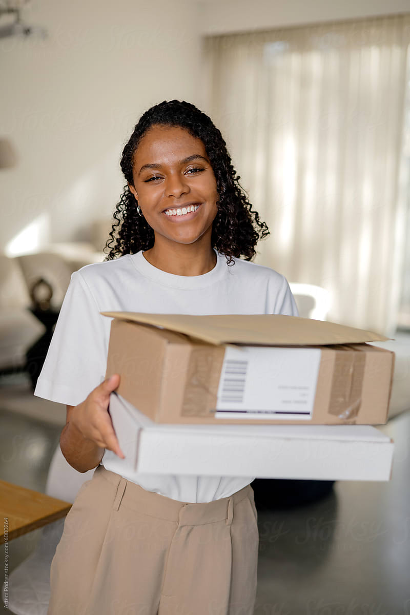 Portrait of a woman with parcel boxes in a Modern home