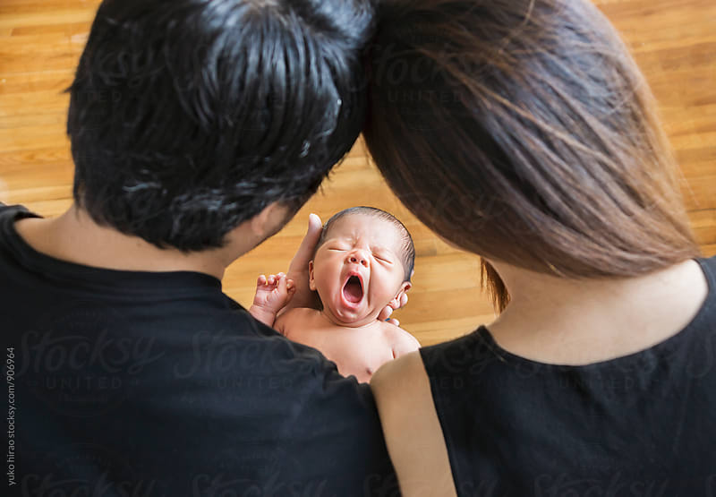 Newborn baby in the center of parents\' attention