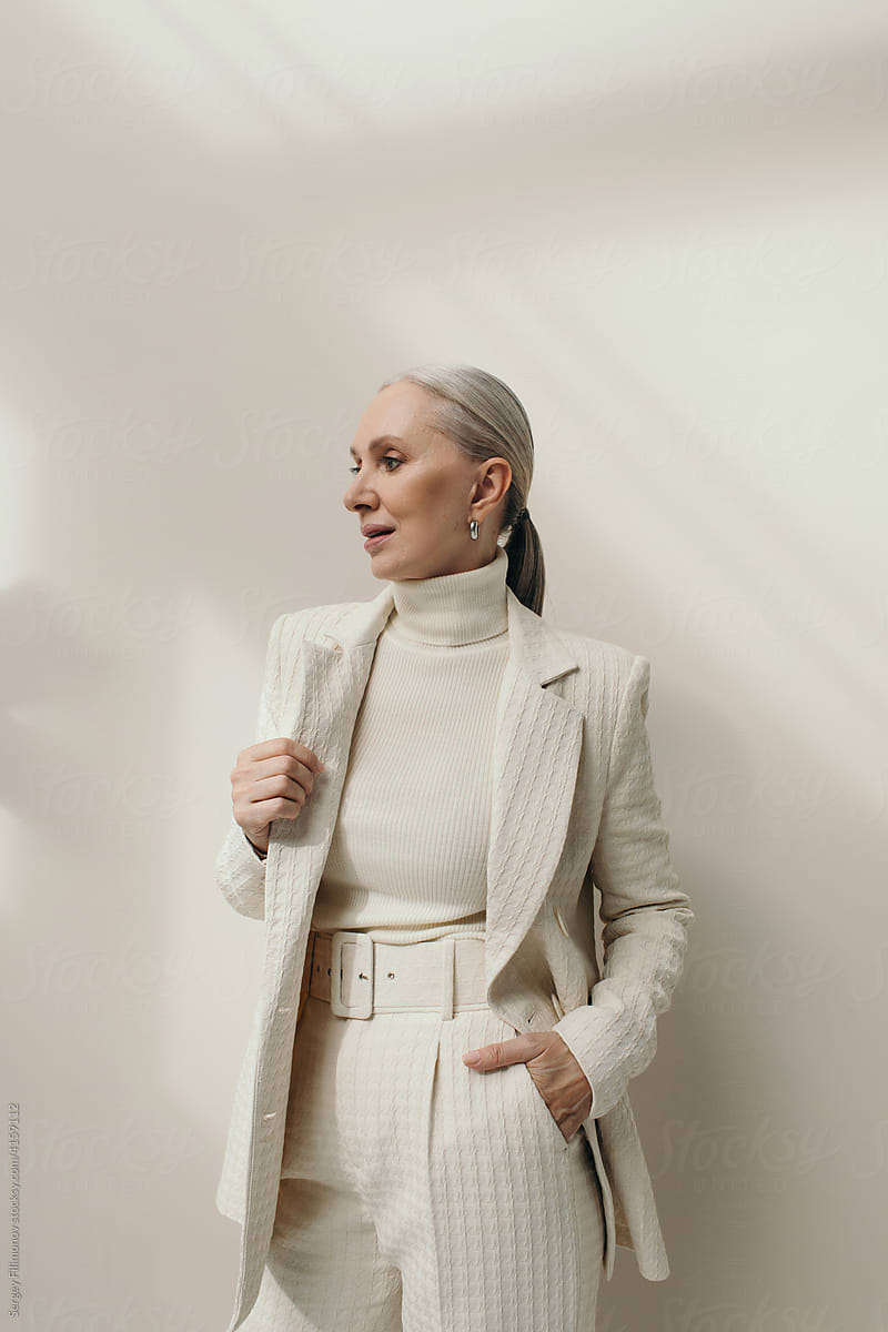 Successful senior woman portrait in white blazer