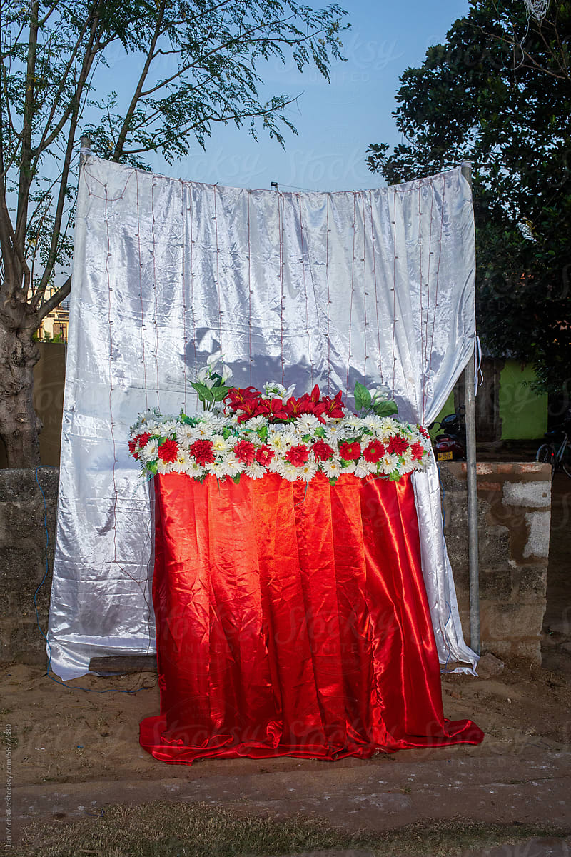 Religious installation with curtains and flowers