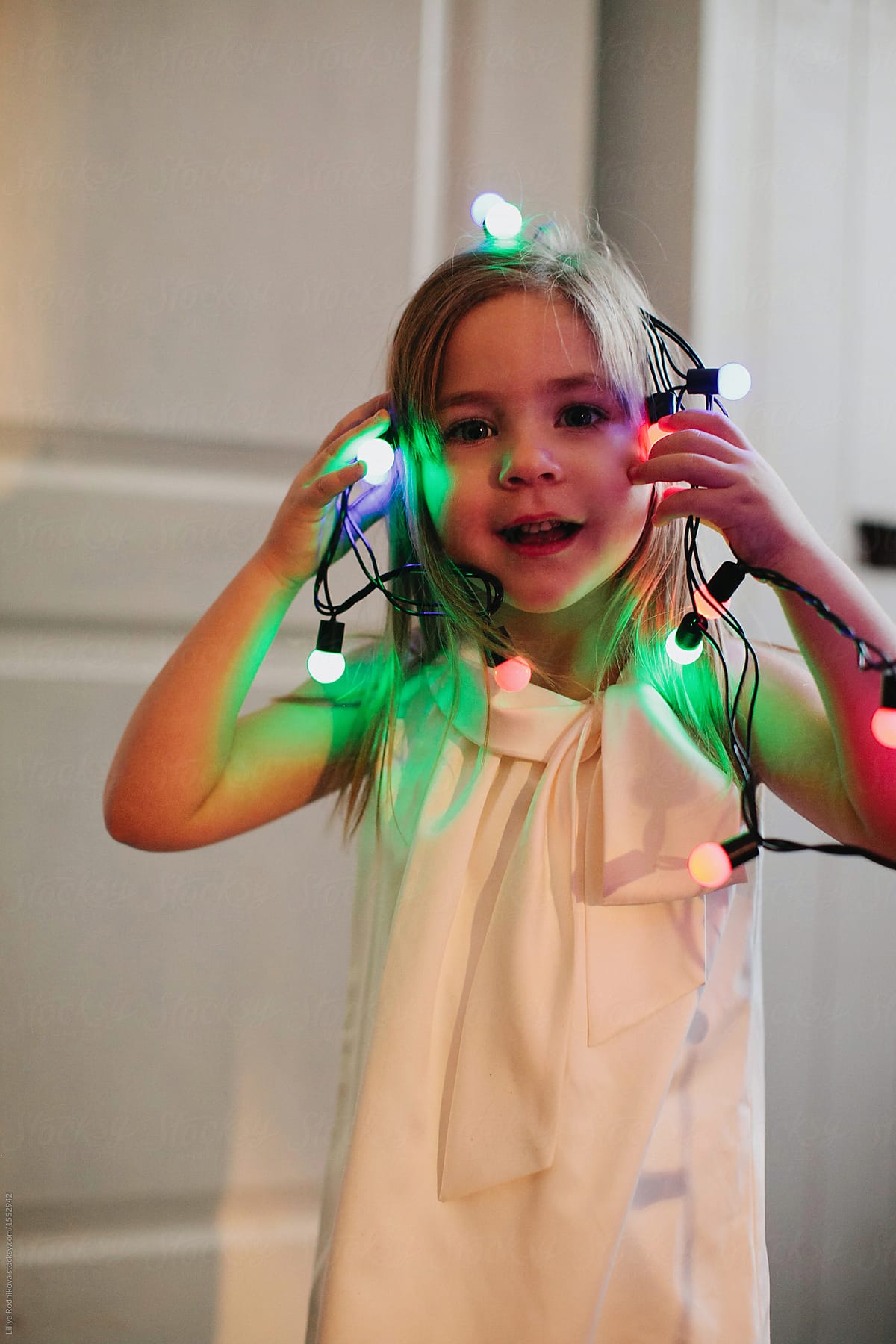 Lovely Girl Playing With Fairy Lights Indoors By Stocksy Contributor lovely-girl-playing-with-fairy-lights-indoors-by-stocksy-contributor