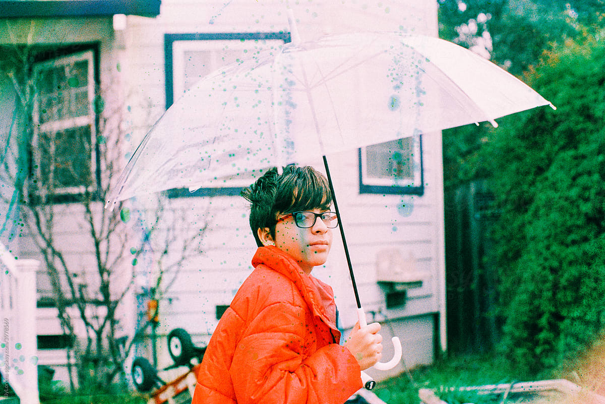 Film Soup teen holding umbrella in red jacket, 35 mm