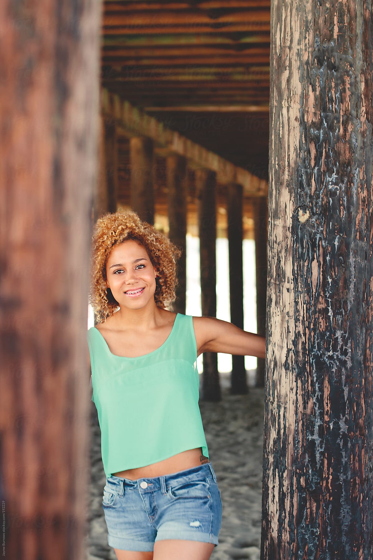 Young Mixed Race Girl Under A Pier By Stocksy Contributor Jayme