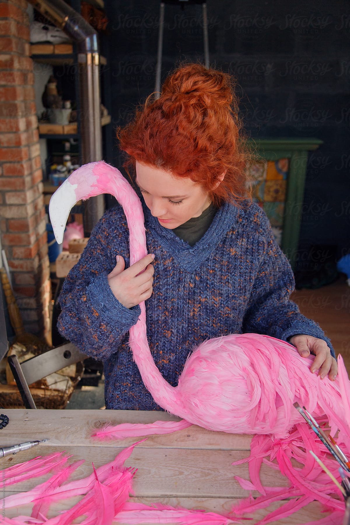 Woman designing flamingo with feathers