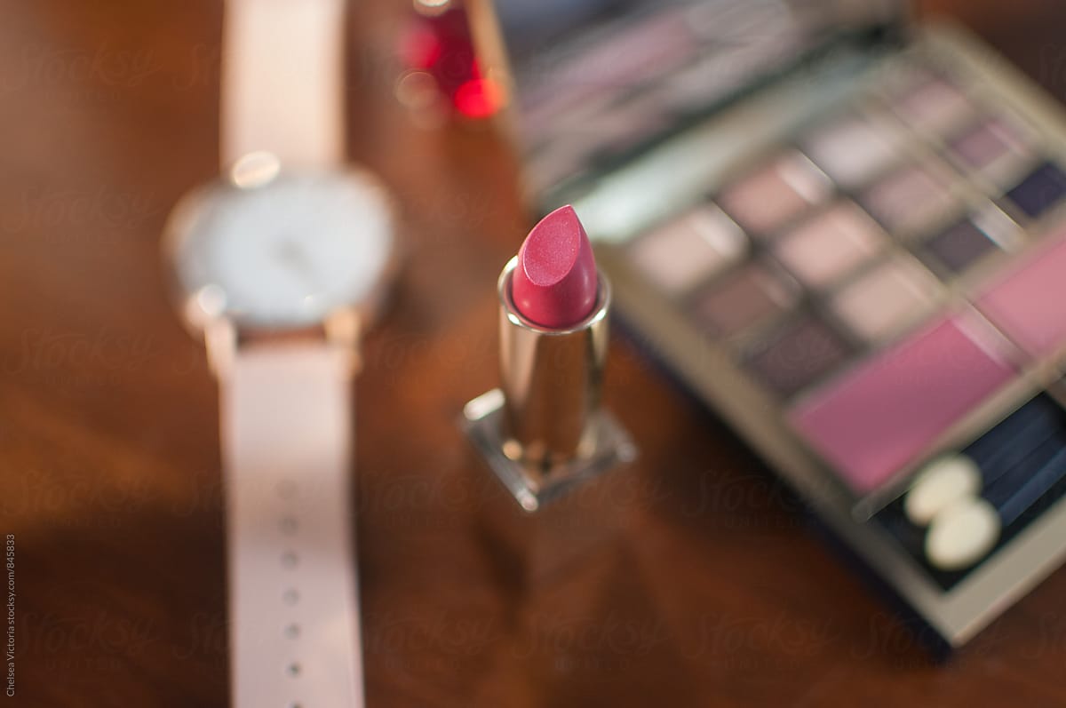 Lipstick and other feminine accessories on a dresser table