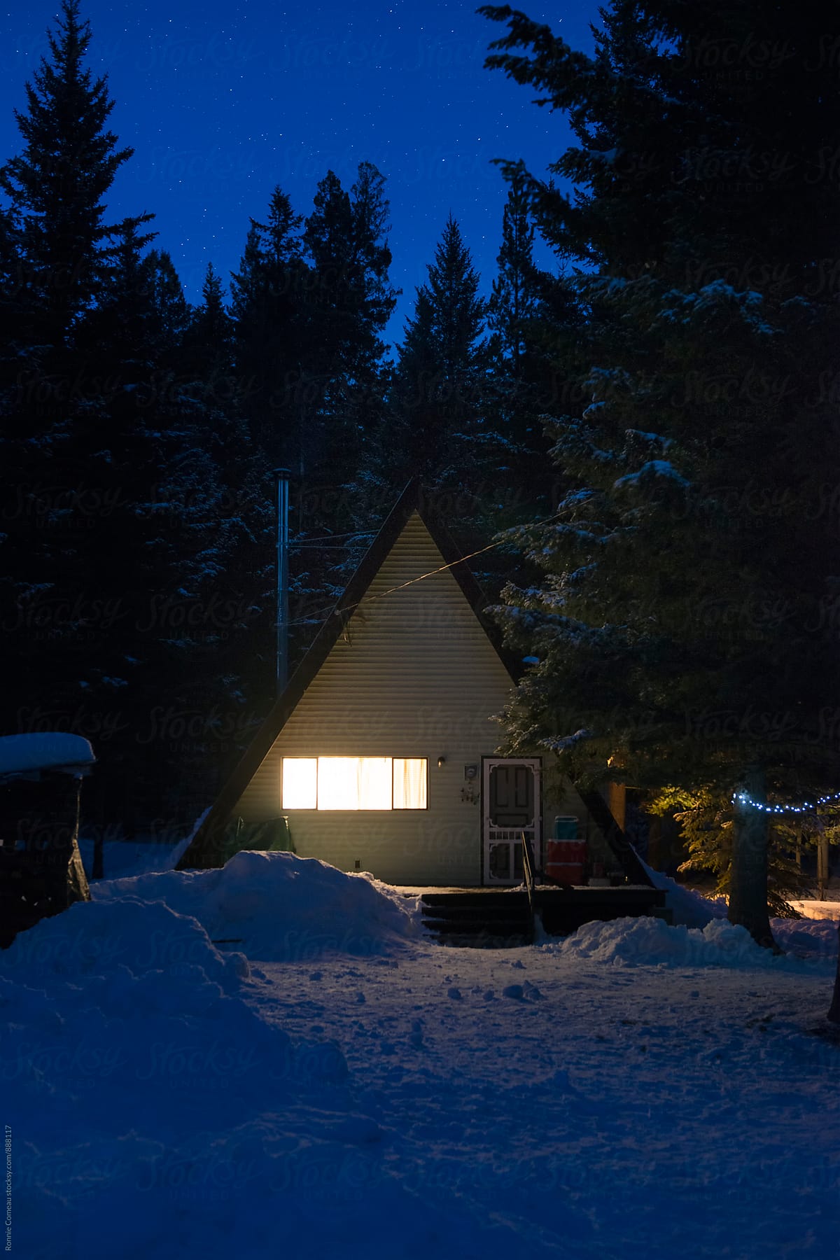 A-Frame Cabin In The Woods In Winter And At Night