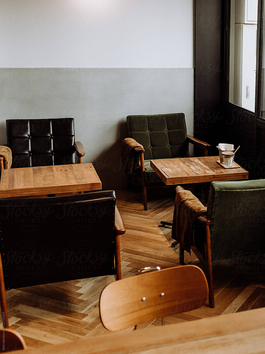 Coffeeshop interior with herringbone wooden floors and leather recliners