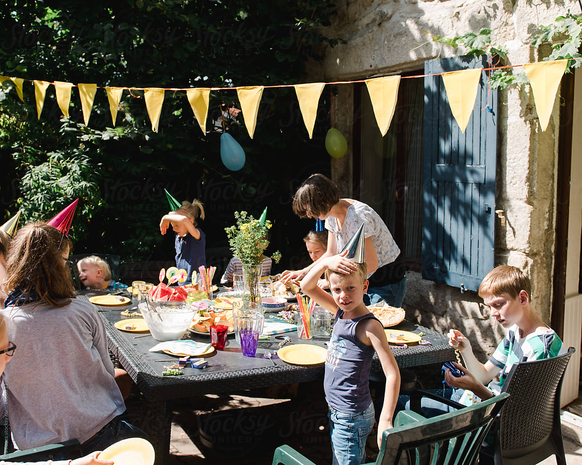 stock photo of kids and mom at birthday party in yard