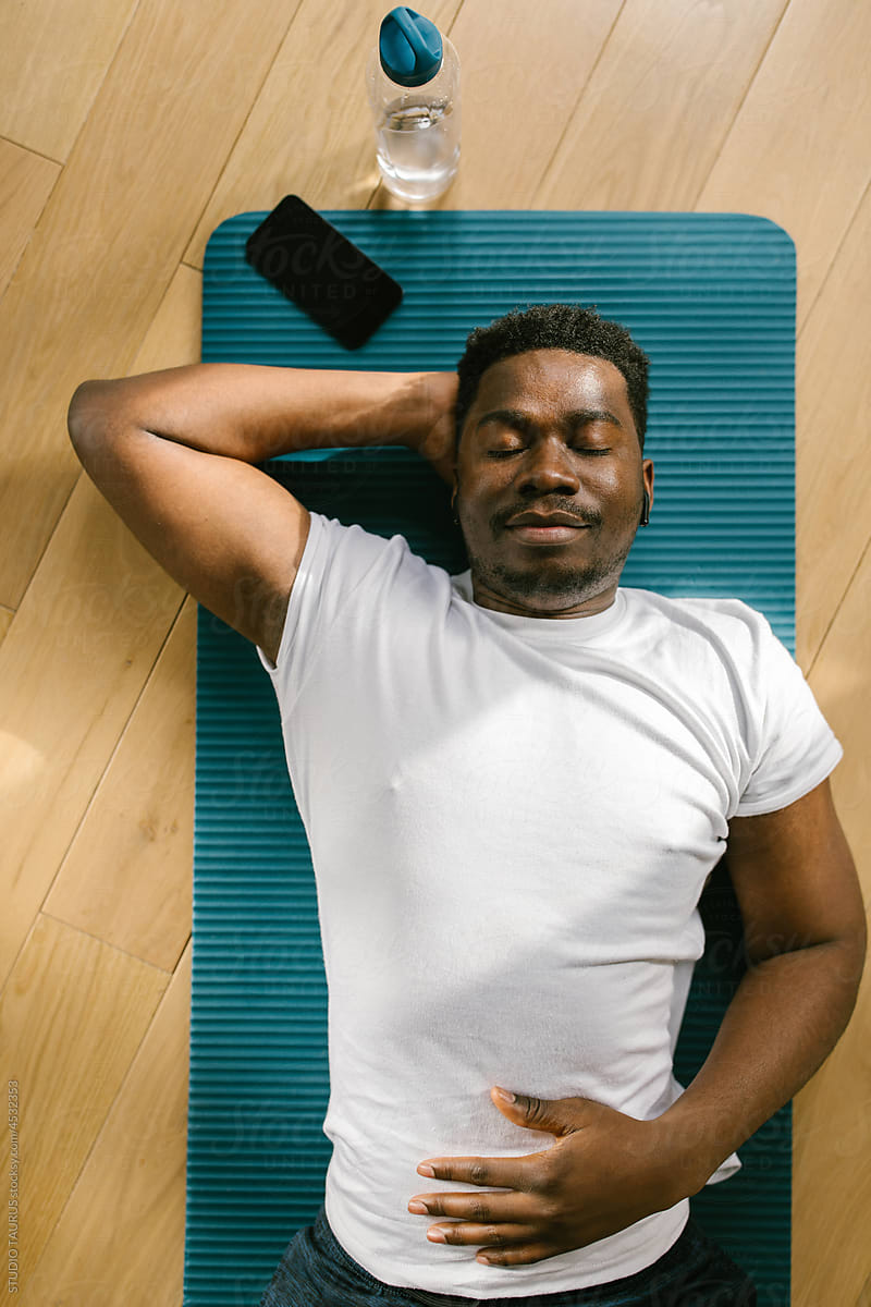 Relaxed man resting after working out indoors
