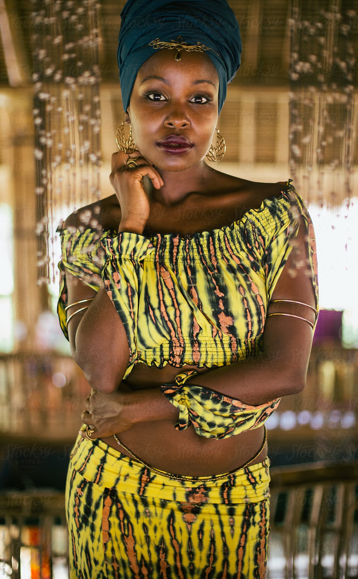 Beautiful african boho woman in tie dyed yellow clothes