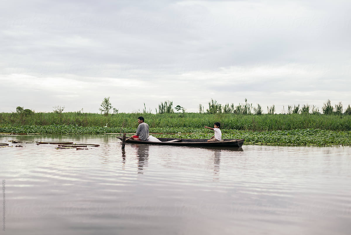 Father and son fishing in the amazon river