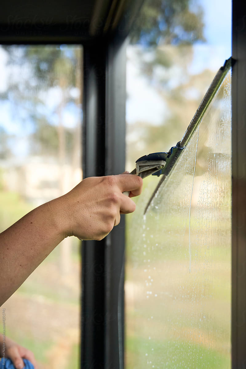 Cleaning window with a squeegee