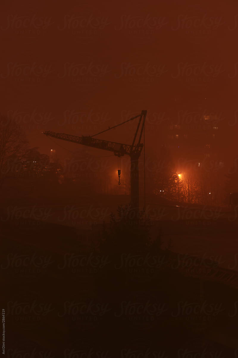 Construction crane in foggy night