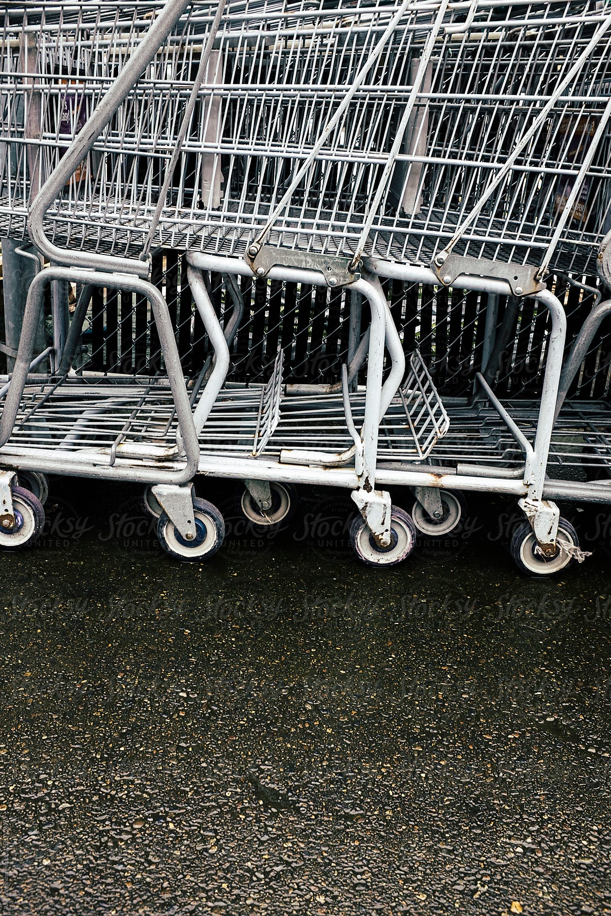 Row of metal grocery carts outside store