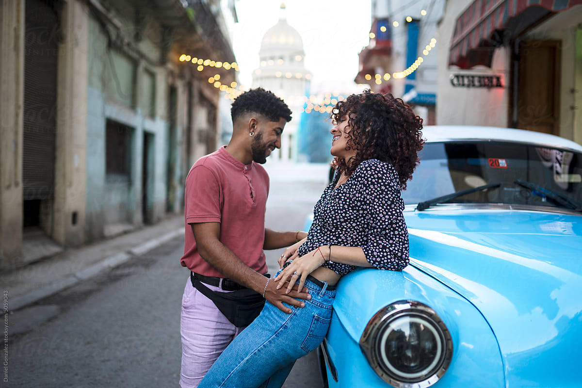 Cuban couple near old timer in city