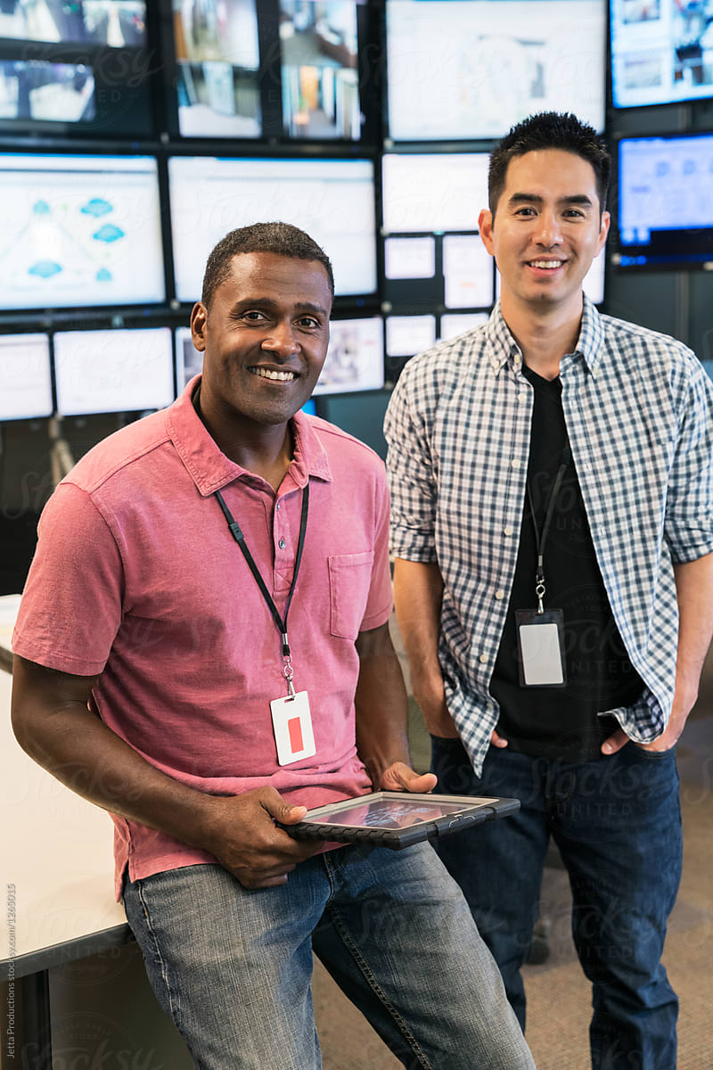 Portrait of two server room technicians smiling