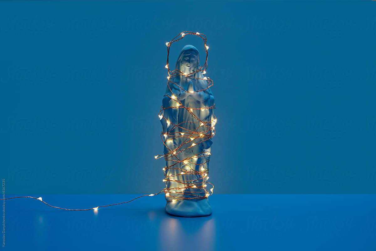 Praying Virgin Mary with glowing garland and halo