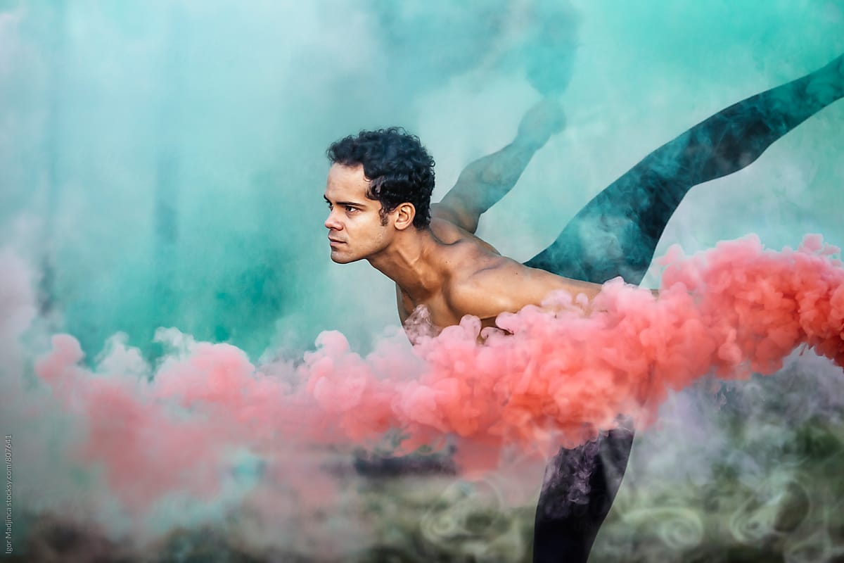 red,ballet dancer with two smoke bombs dance in nature