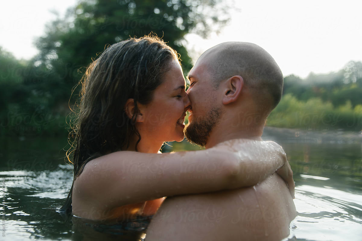 Happy young couple hugging in water