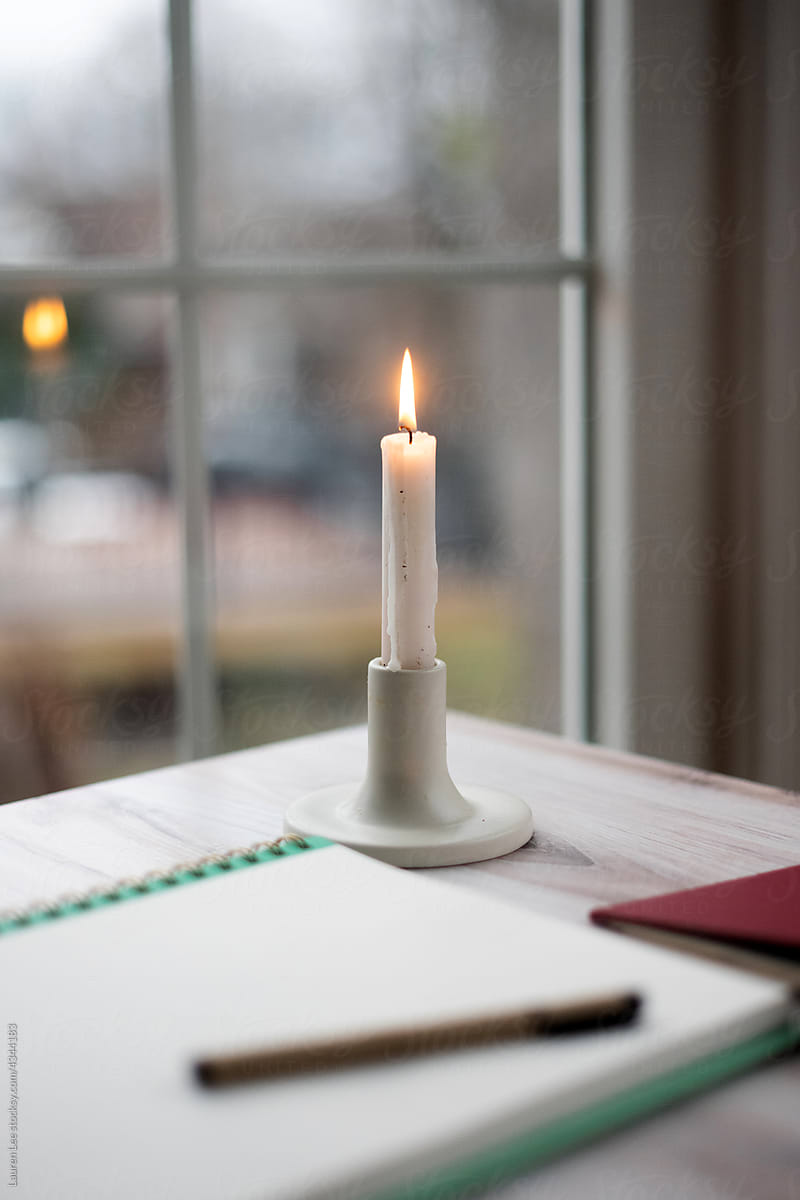 Single candle burning on table
