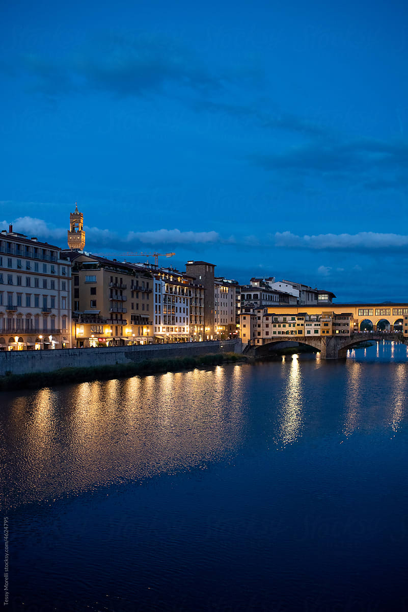 Night street view of Florence with blue sky and river