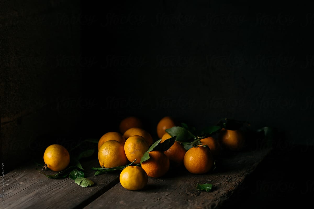 cluster or tangerines on wooden farm table