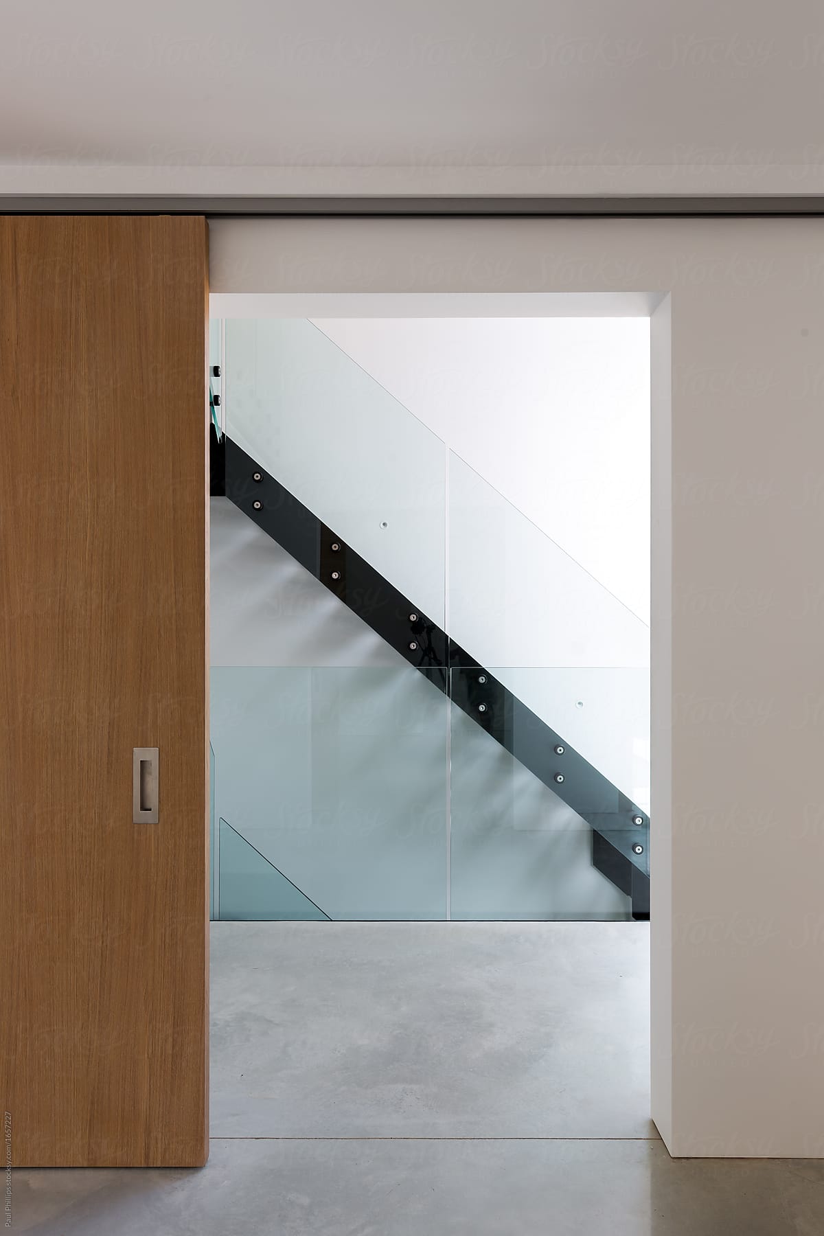 Simple domestic modern staircase viewed through a sliding door.