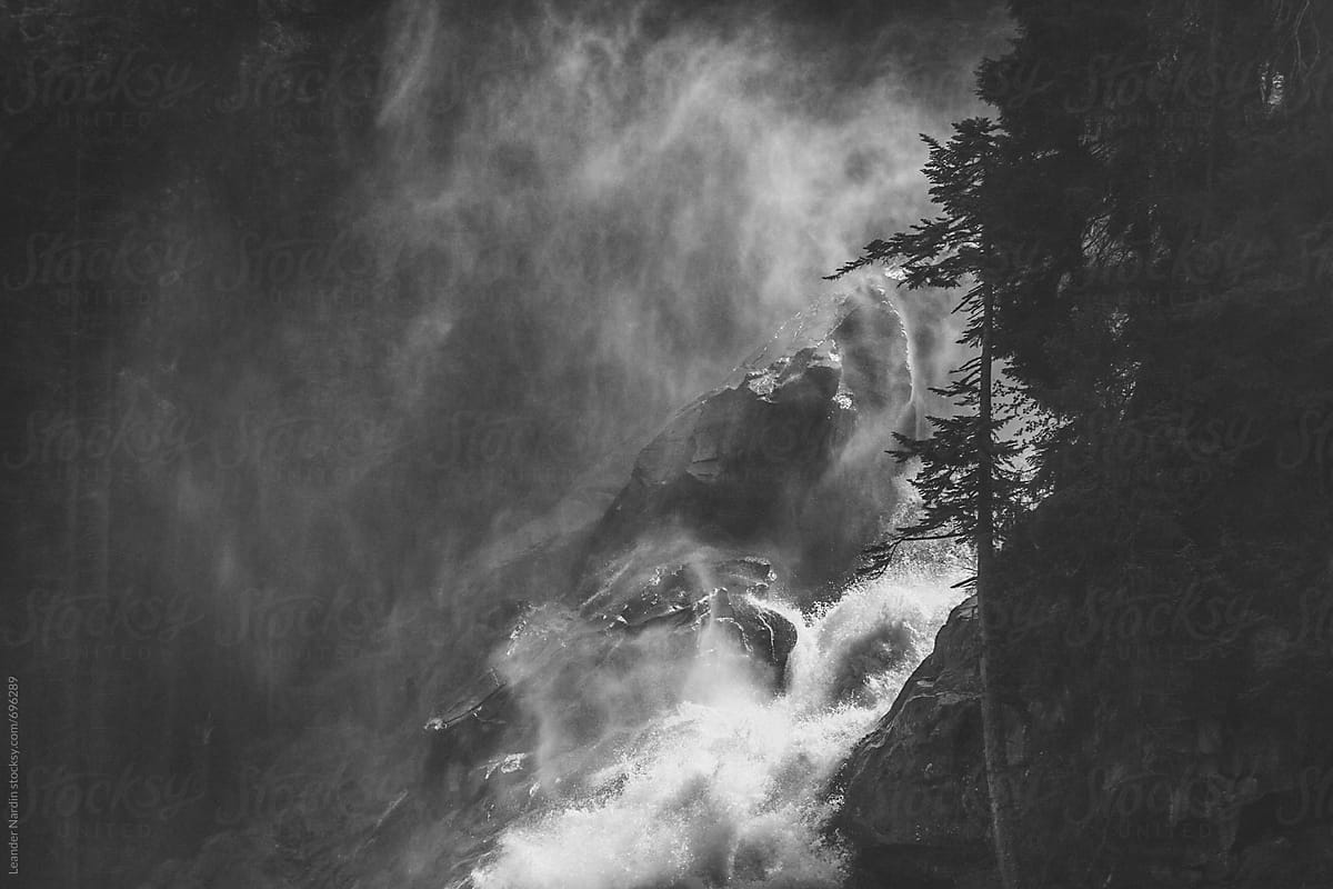 detail of a river flowing down a mountain - black and white