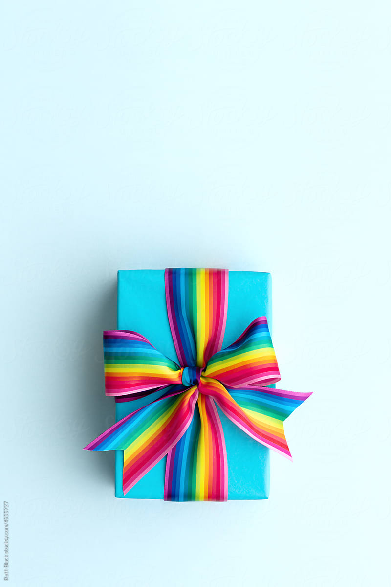 Gift box wrapped with a rainbow bow
