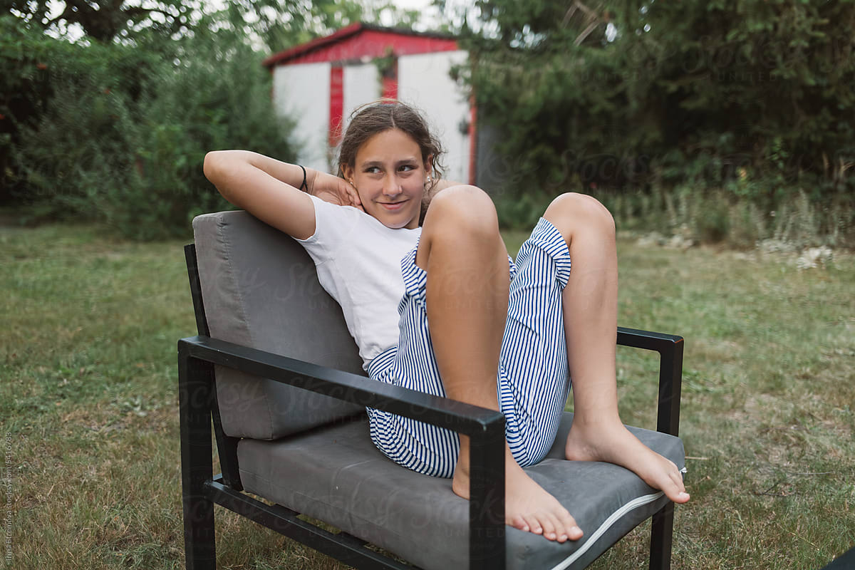 Barefoot Girl sitting on Garden Chair