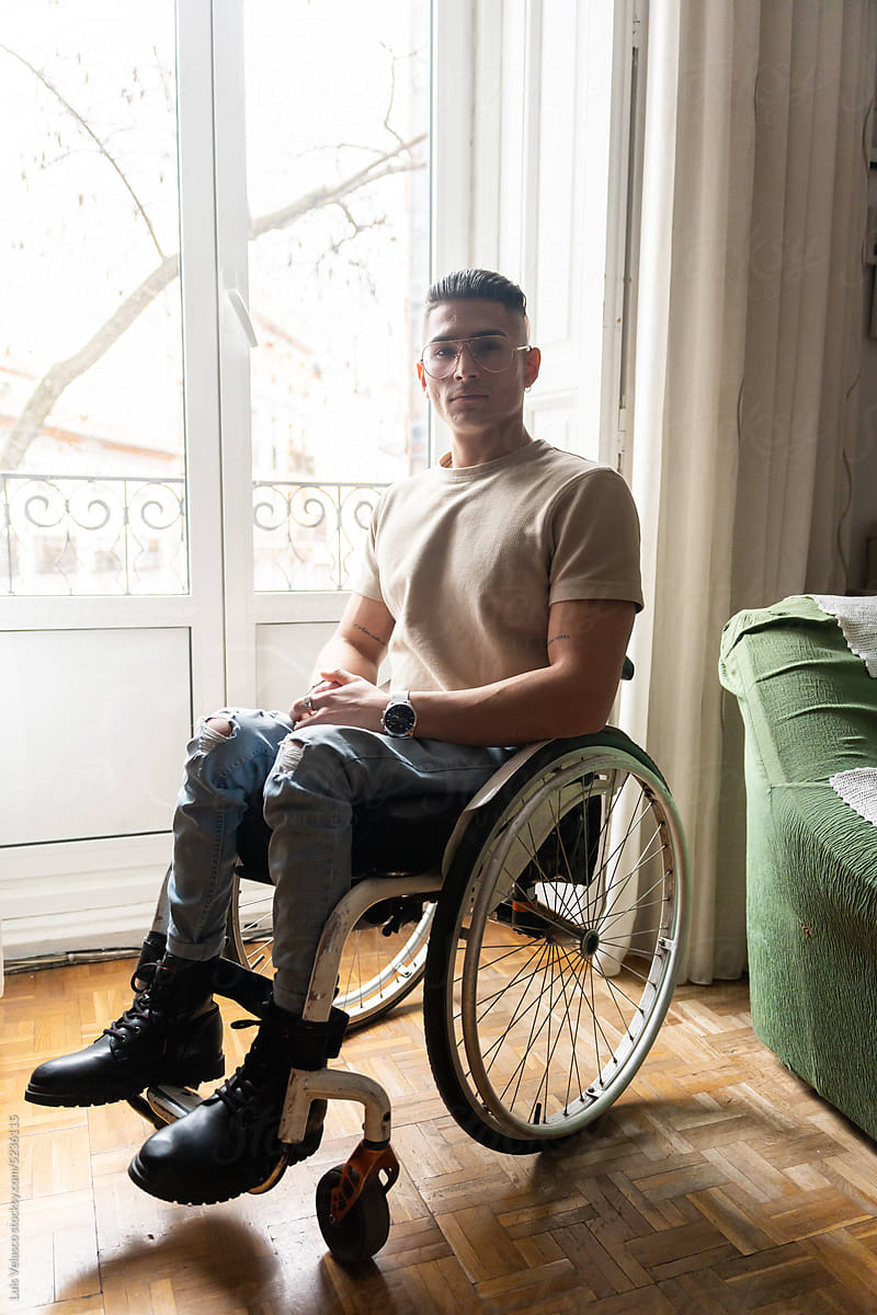 Portrait Of Young Man With A Disability At Home Looking At Camera.