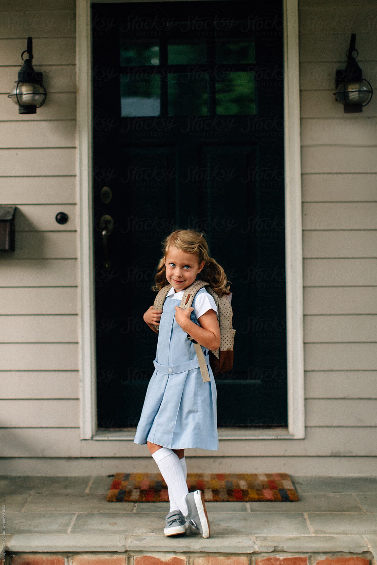 little girl in uniform on her first day of kindergarten