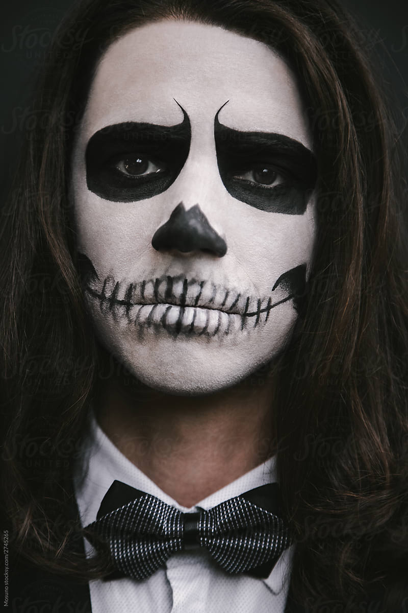 portrait of young man with skull Halloween facepaint