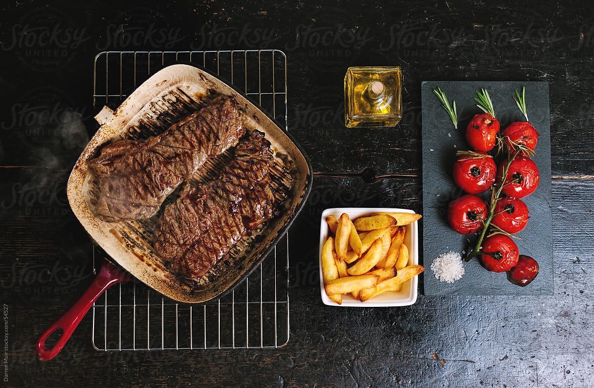 Steak,Chips and roasted vine tomato.