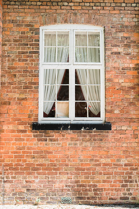 window in brownstone wall
