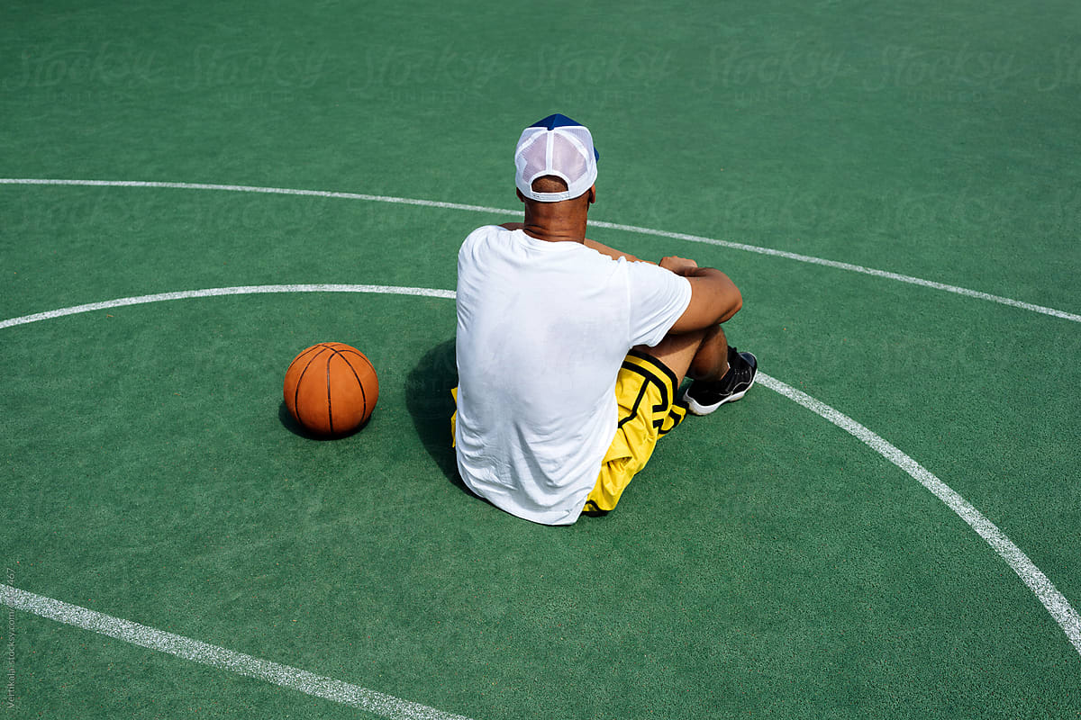 Anonymous fit black guy on a basketball court