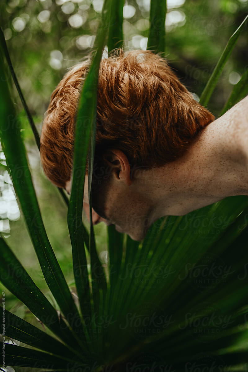 Half-Face Portrait and Neck of Freckled Ginger Man in the Leaves