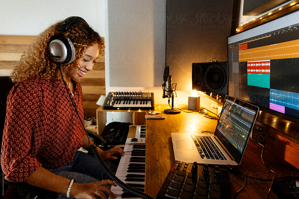 Happy Music producer working at home studio using keyboard controller