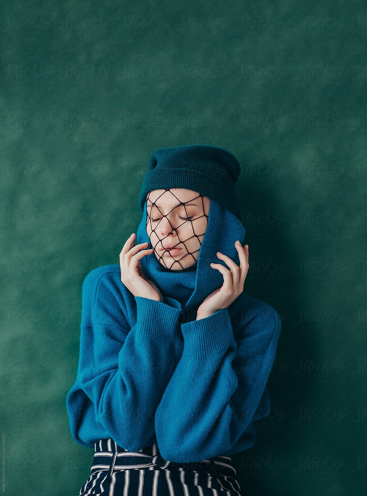 Stylish woman with net on face