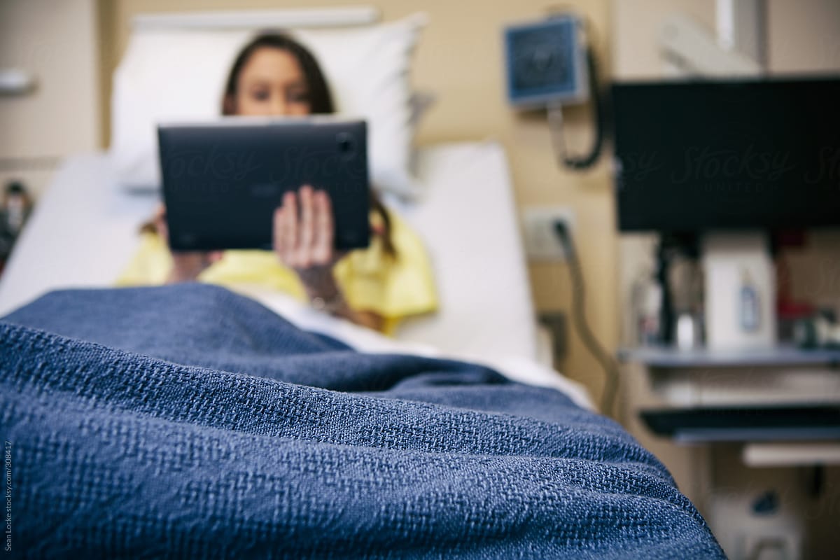 Hospital: Female Patient Using Digital Tablet In Bed