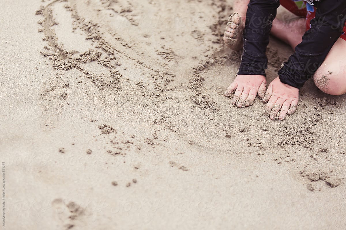 Young child playing in the sand at a beach