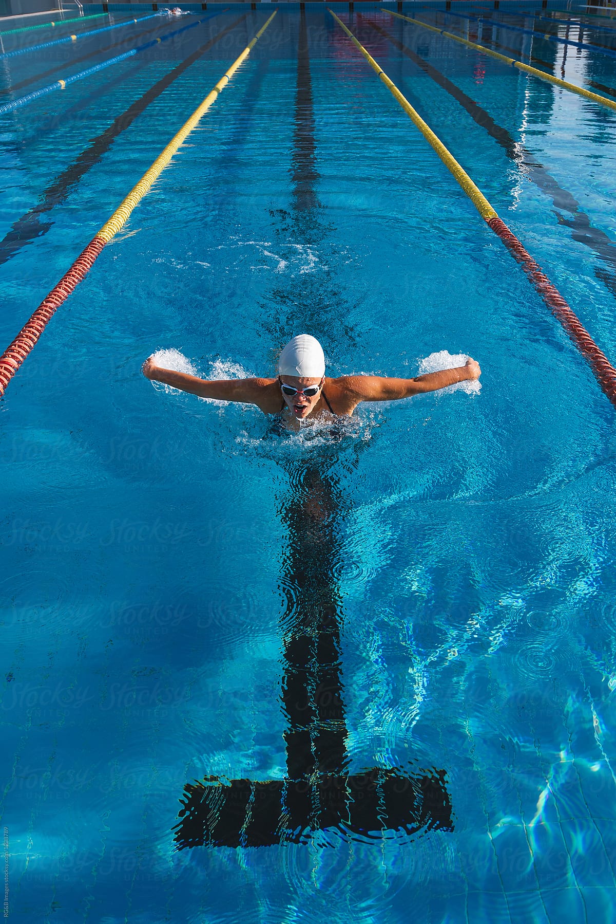Woman doing intense training with butterfly swimming technique