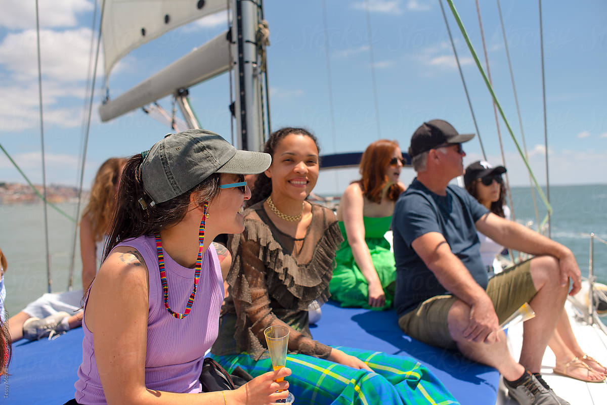 Group of diverse tourist traveling on a sailing boat