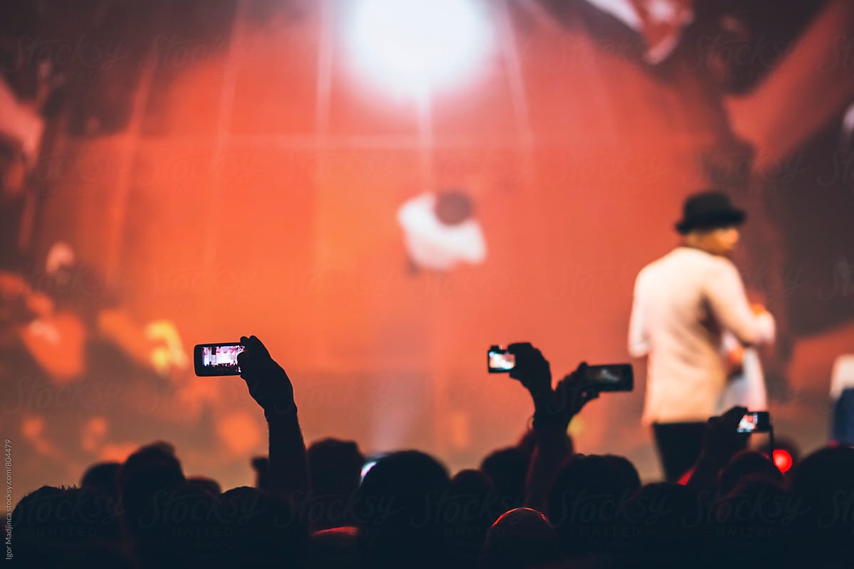 audience with mobile phones,stage,red