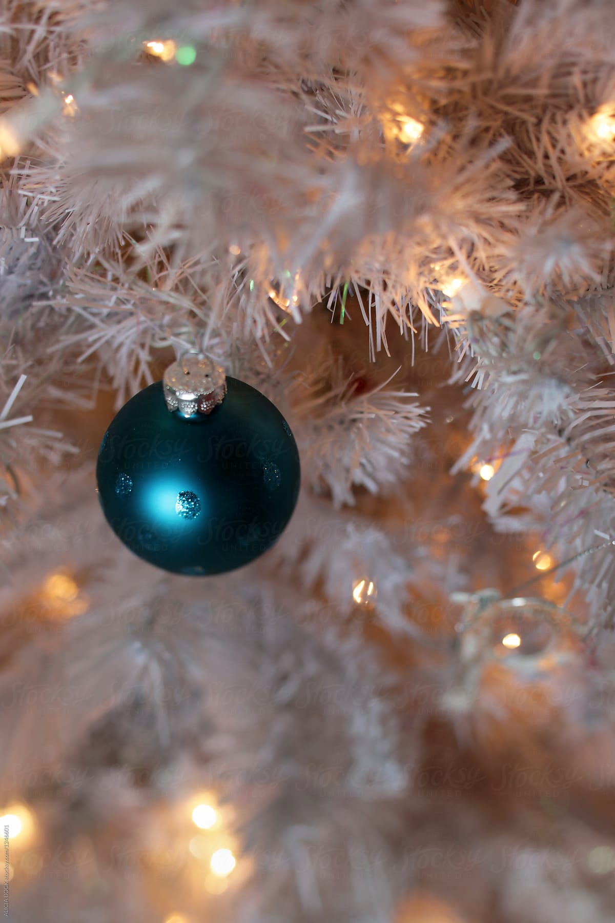 A Round Blue Christmas Ornament On A Vintage Christmas Tree