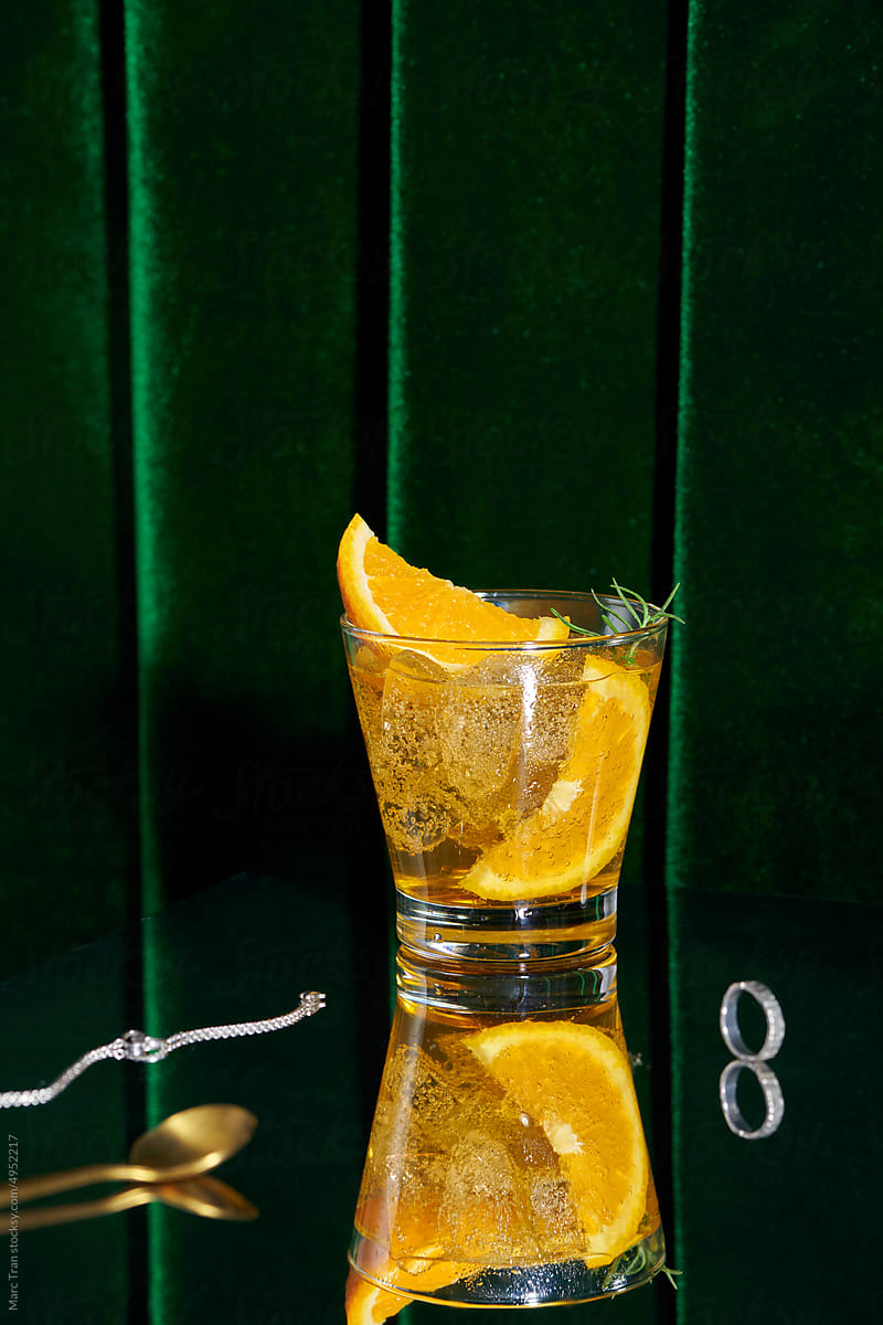 Summer orange cocktails with fresh citrus fruits on velvet background
