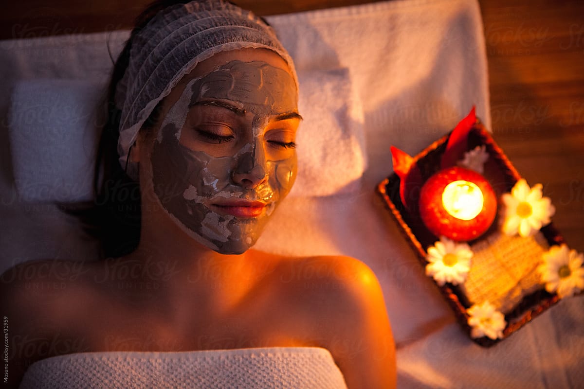 Woman with a facial mask in a spa center.