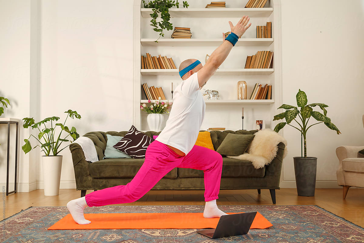 Man doing crescent lunge pose at home