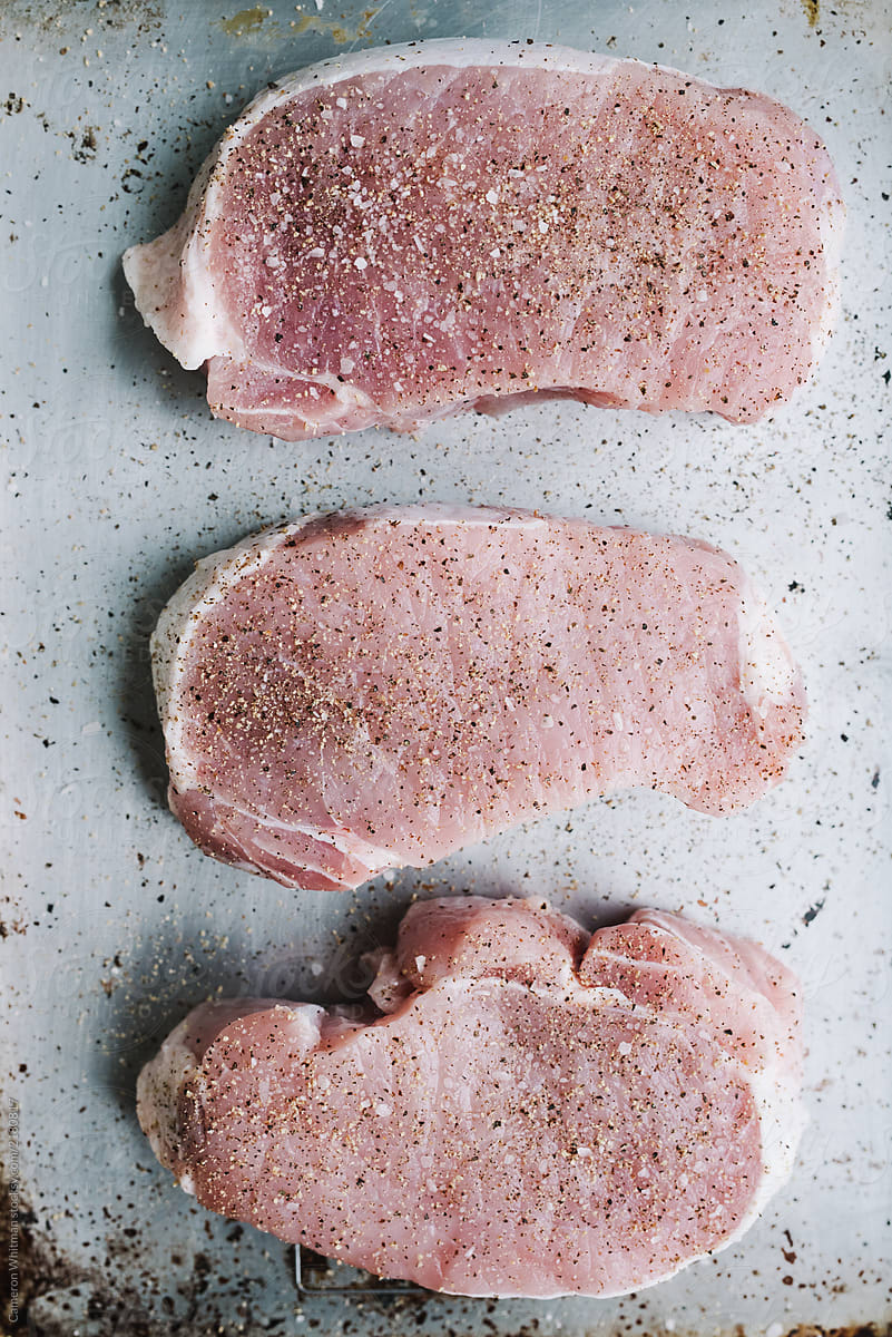 Raw pork chops ready to go on the skillet
